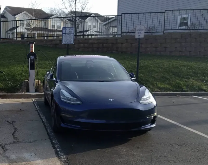 A blue Tesla Model 3 charging at the University of Dayton in Ohio