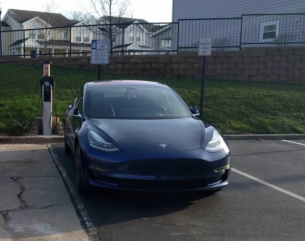 A blue Tesla Model 3 charging at the University of Dayton in Ohio