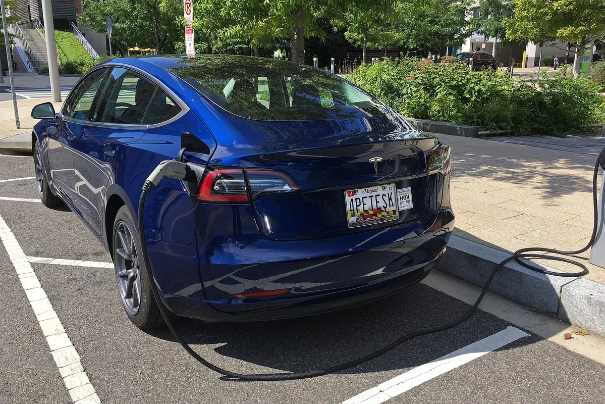 Rear view of a Tesla Model 3 charging at a ChargePoint on street public charging station. Washington, D.C